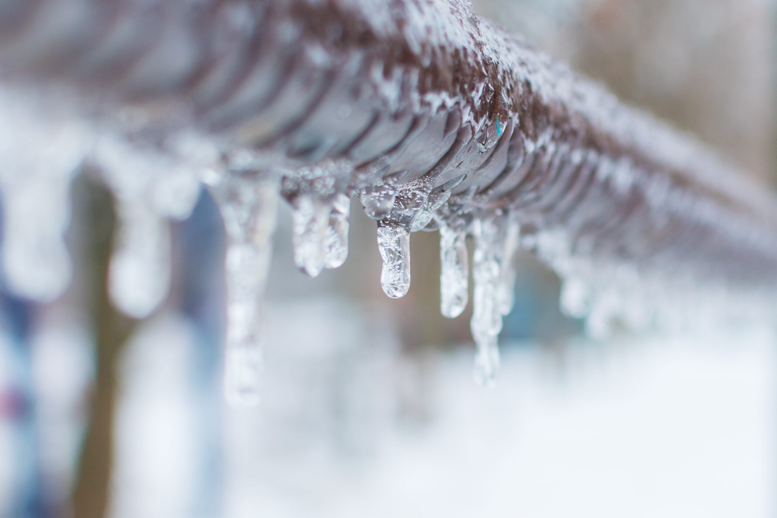 water pipe with icicles hanging off of it